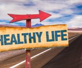 Healthy Life sign with road background